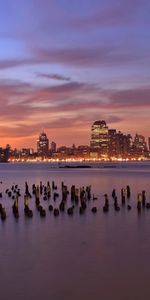 Ríos,Puesta Del Sol,Cielo,Noche,Nubes,Rascacielos,Luces,Las Luces,Pilares,Ciudad De Jersey,Hudson,Estado De Nueva Jersey,Columnas,Ciudades,Ee Uu,Estados Unidos,Lila,De Madera,Iluminación,Iluminar Desde El Fondo