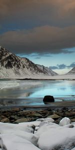 Sky,Mountains,Clouds,Shore,Bank,Gull,Nature,Stones,Bird,Seagull,Ocean,Cold,Snow,Gloomy