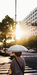 Sun,Miscellanea,Person,City,Human,Street,Umbrella,Miscellaneous